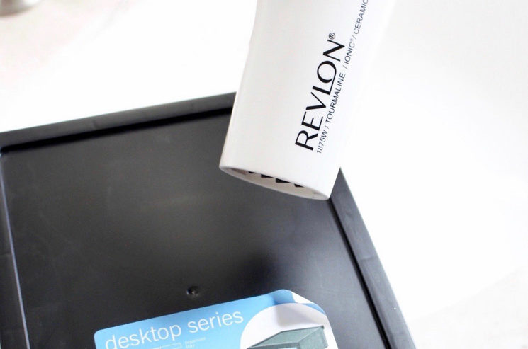 Use a blow dryer to remove a sticker from the back of a picture frame.