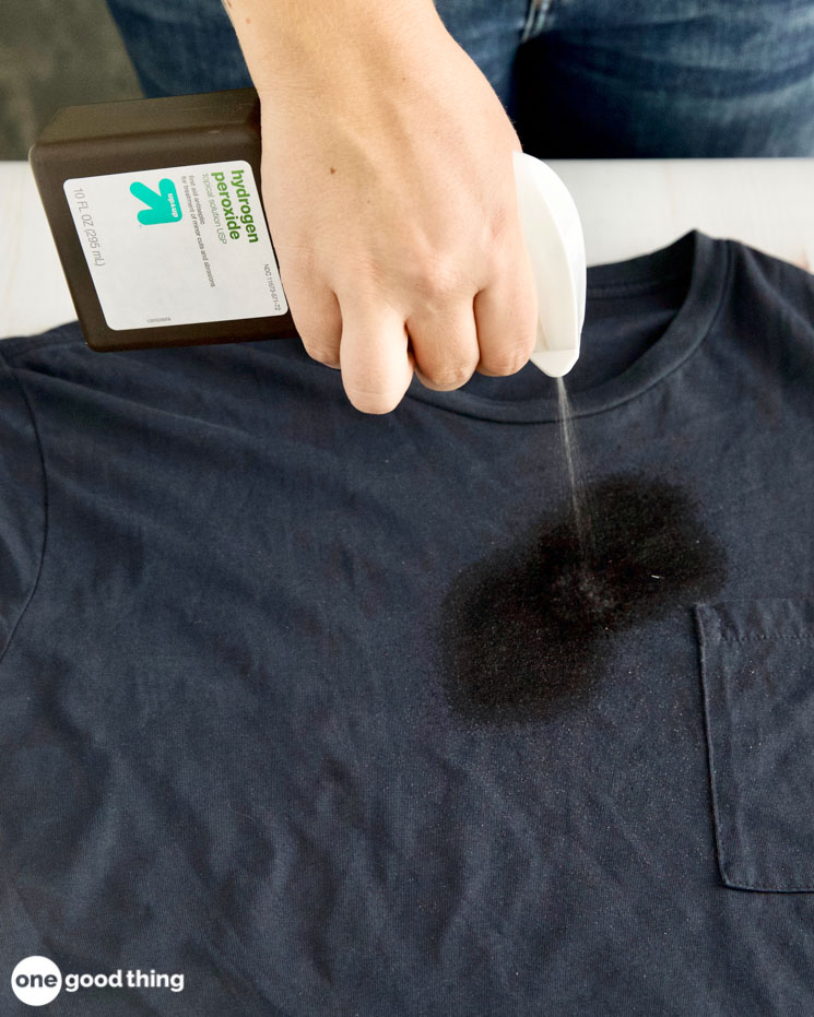 How to get oil stains out of clothing. First step to getting out oil stains is to spray the stain with hydrogen peroxide.