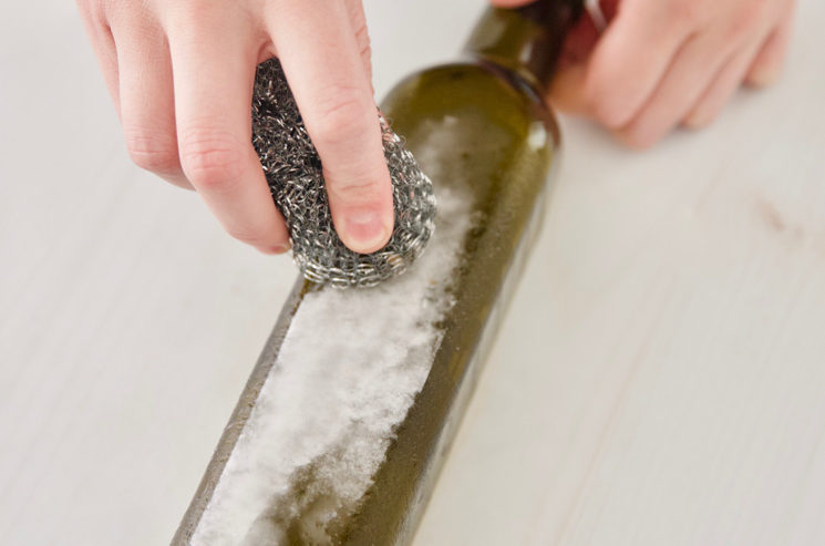 using DIY Goo Gone Gunk Remover and a scrubby on label residue